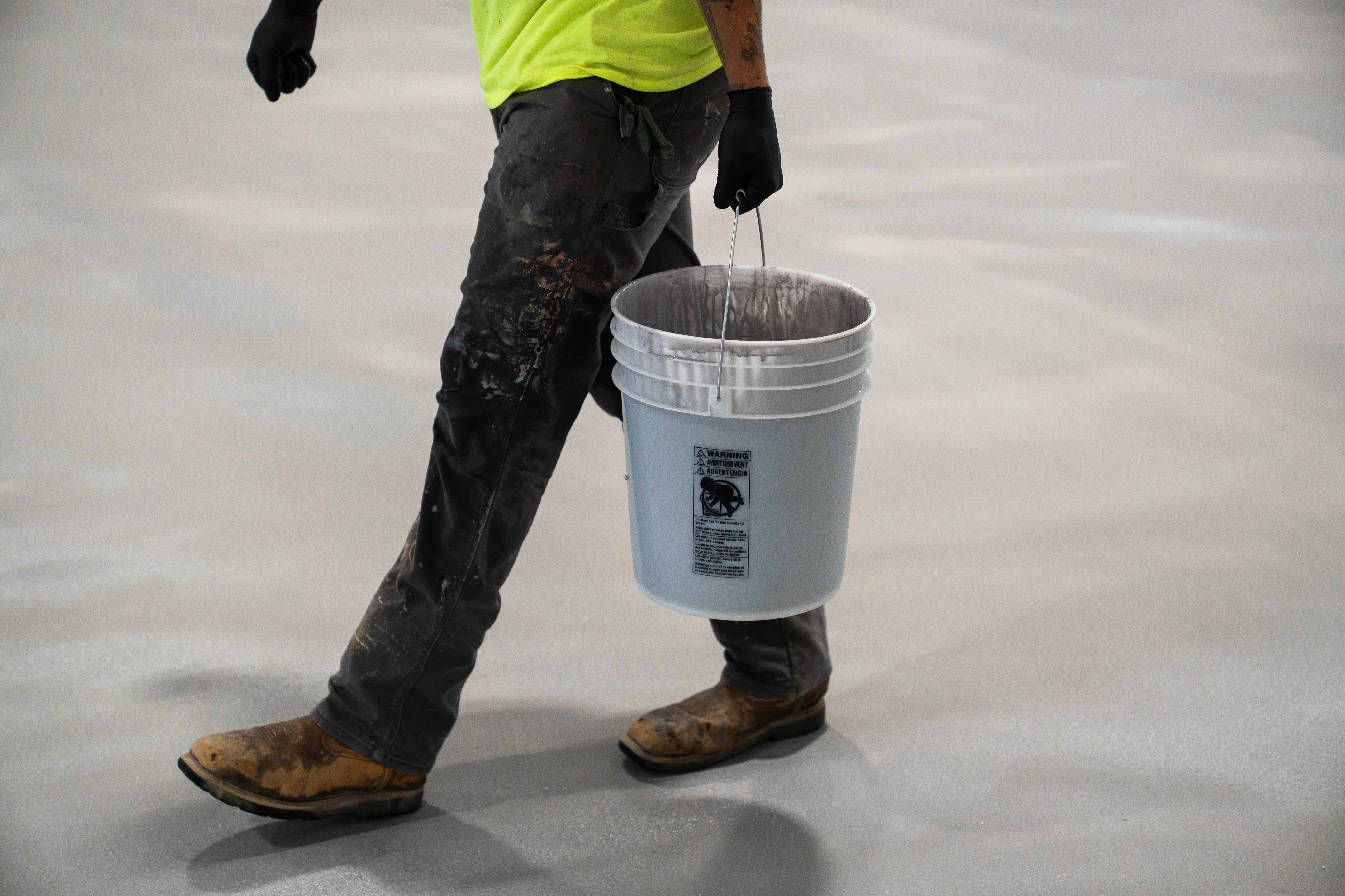Person carrying a bucket