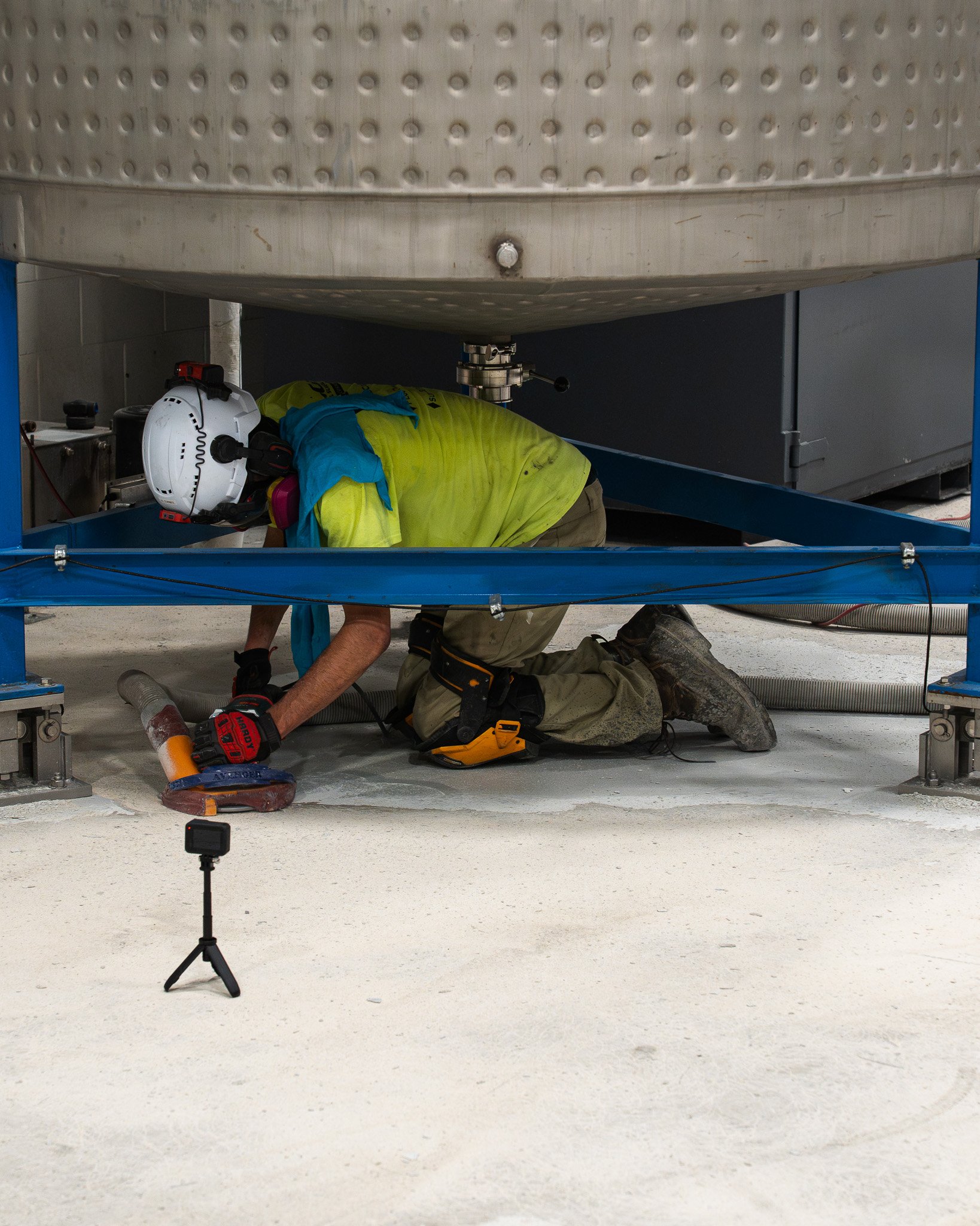 Hand grinding under equipment