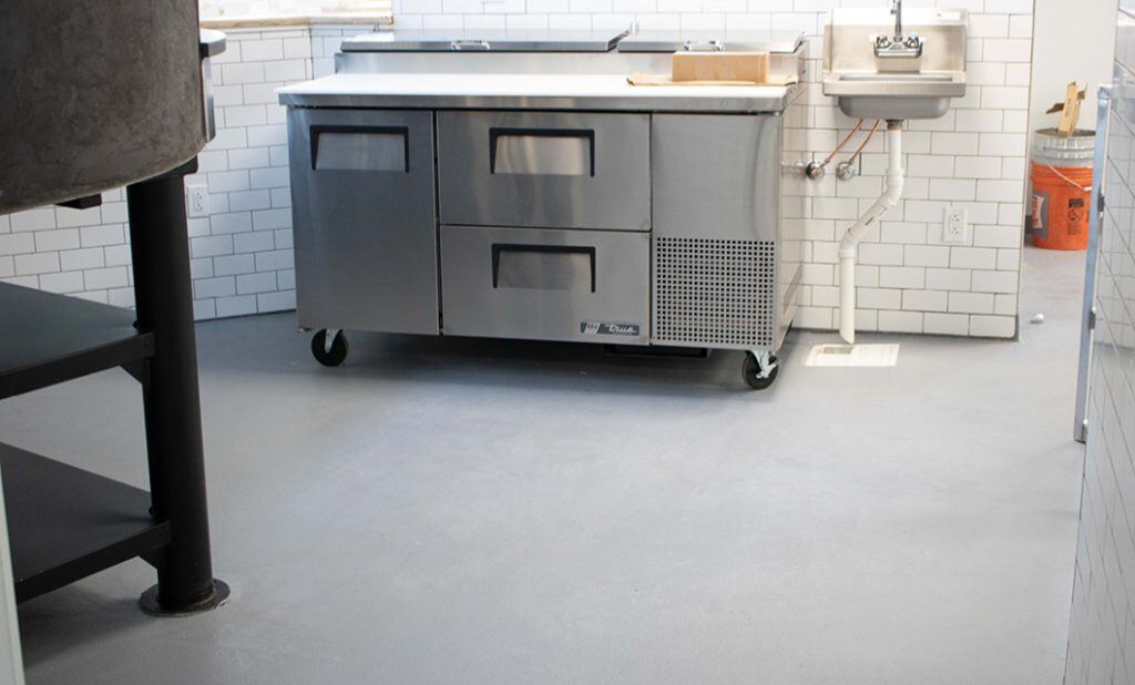 grey colored Urethane Cement in a Kitchen with rolling countertop and sink