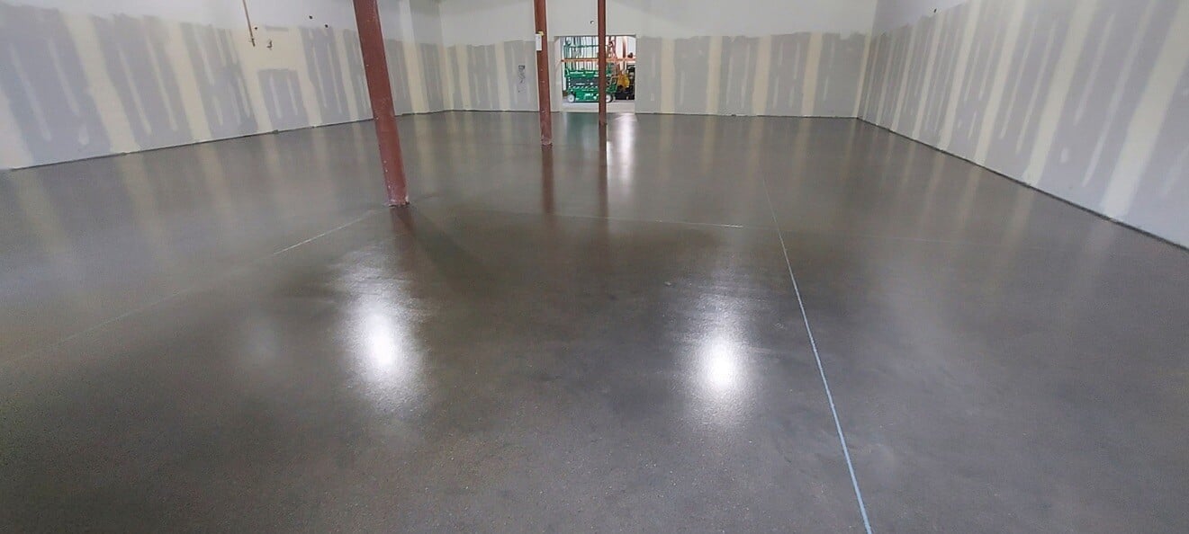 sealed concrete flooring with red support pillars