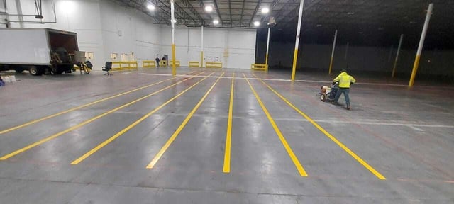 CustomCrete worker preparing a concrete floor