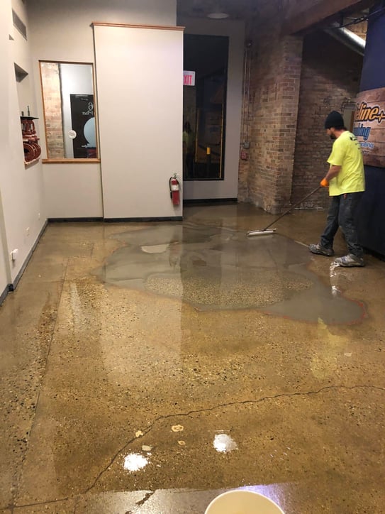 Worker installs an epoxy floor