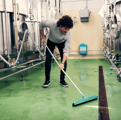 Worker Cleans a Urethane Cement Floor_ Resist Thermal Shock
