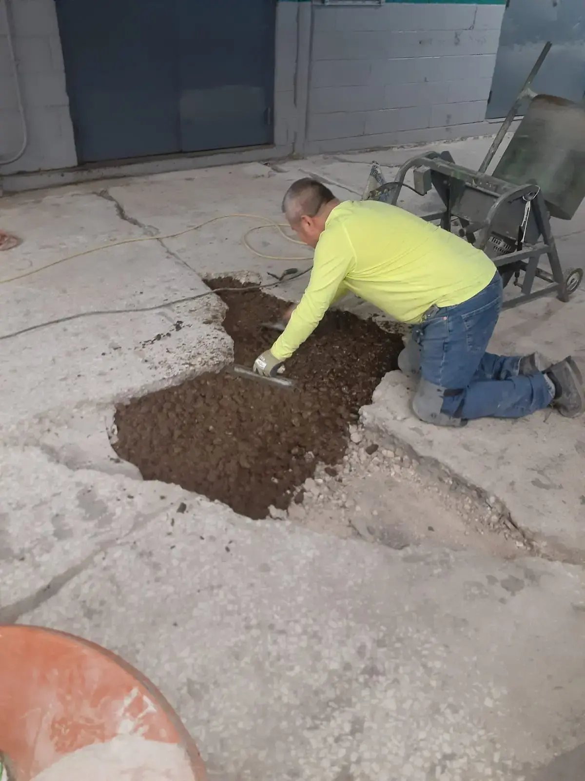 customcrete worker fills a large crack in concrete floor, illinois plant