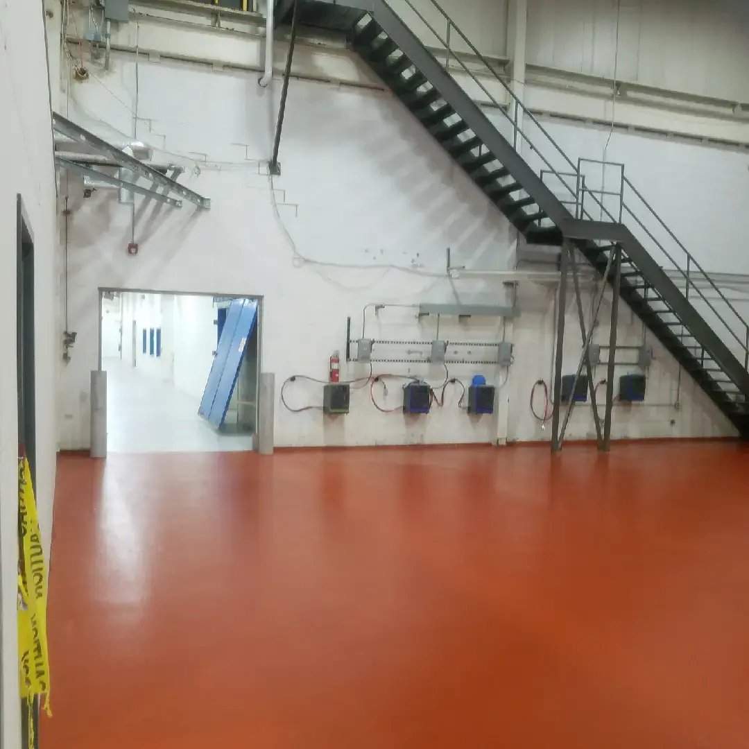 red Urethane Cement flooring on a production floor with staircase