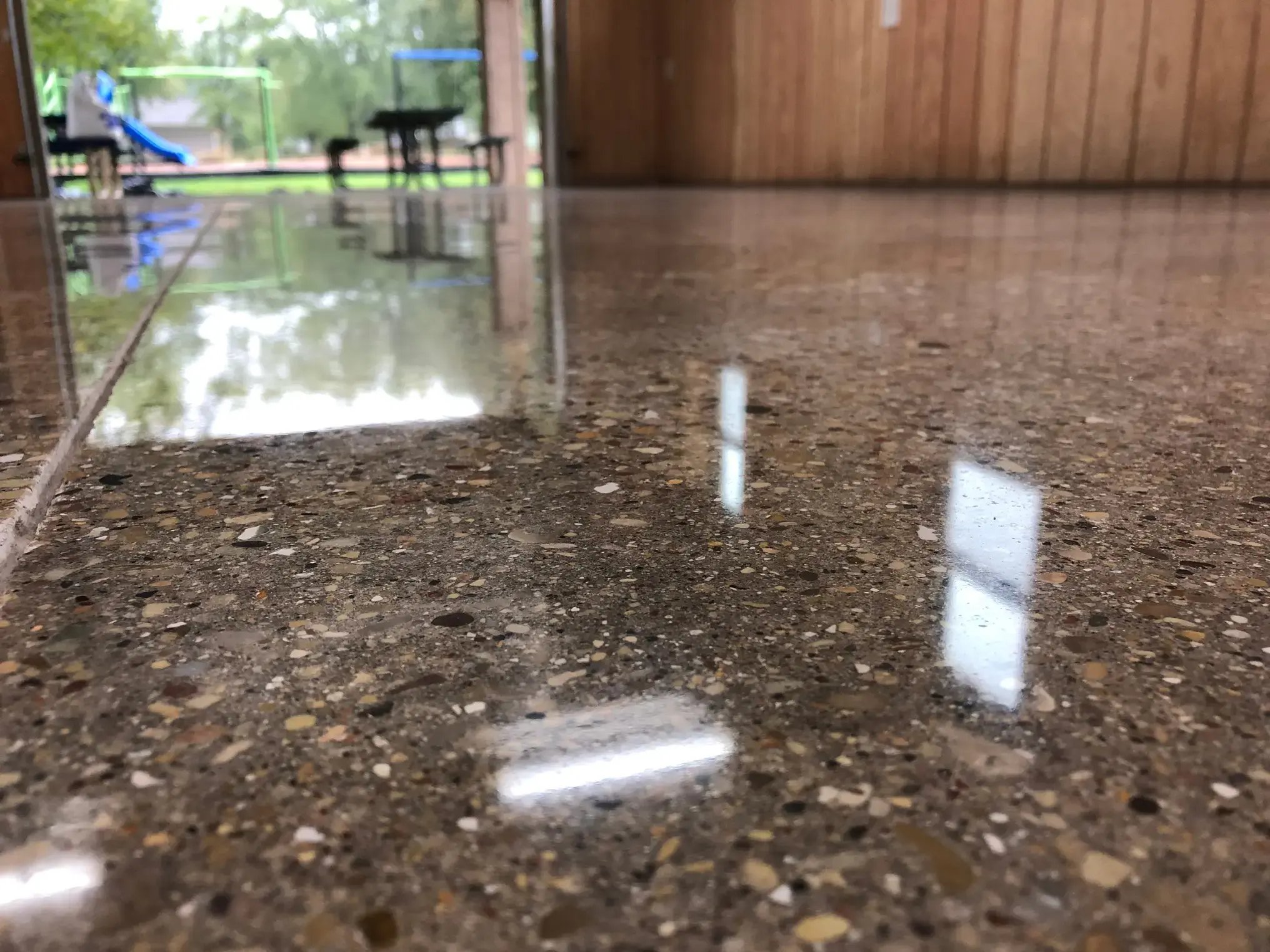 Polished Concrete flooring with a double door looking out onto a park