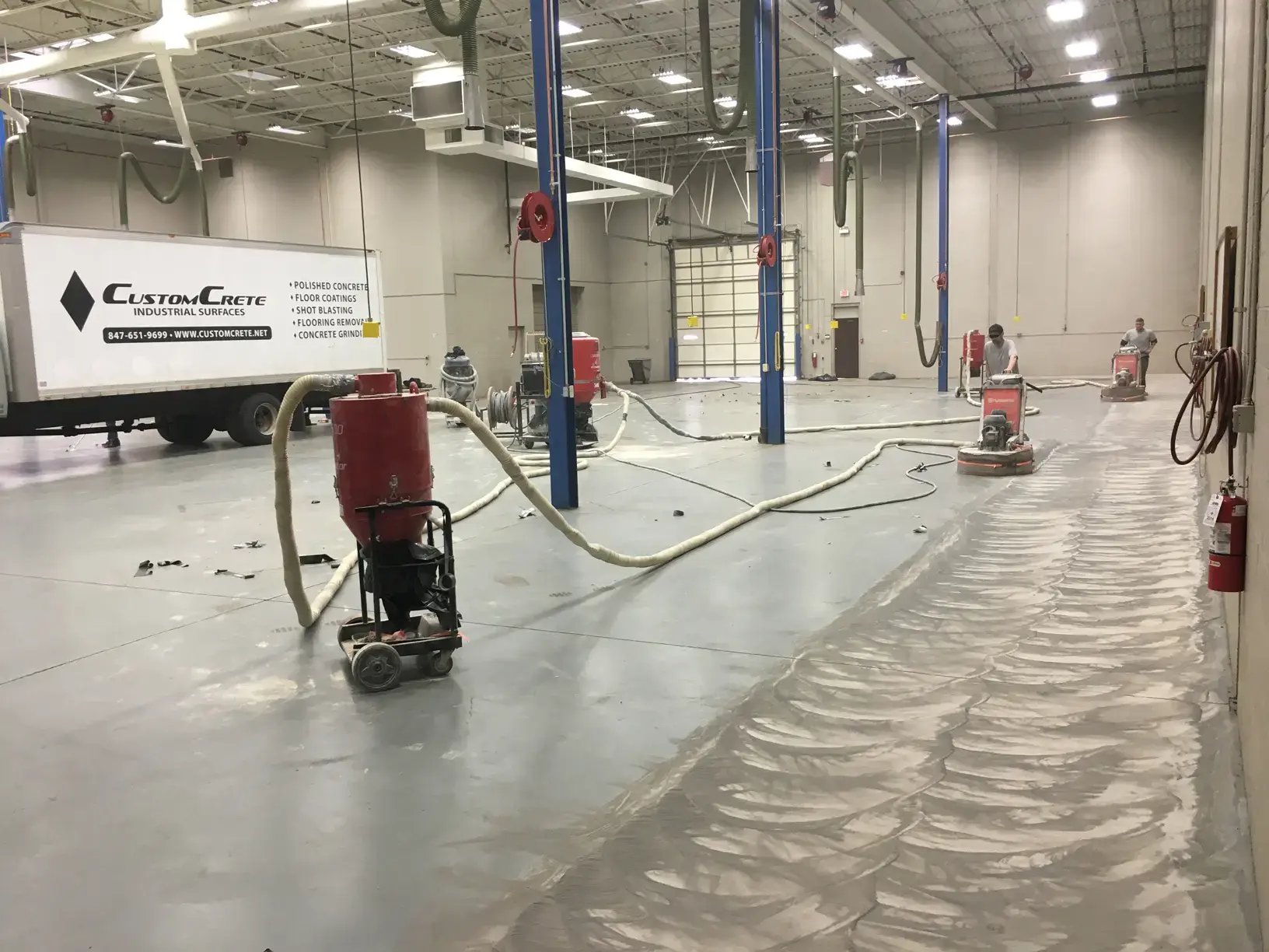 customcrete truck in a loading dock while laborers do Concrete Preparation 
