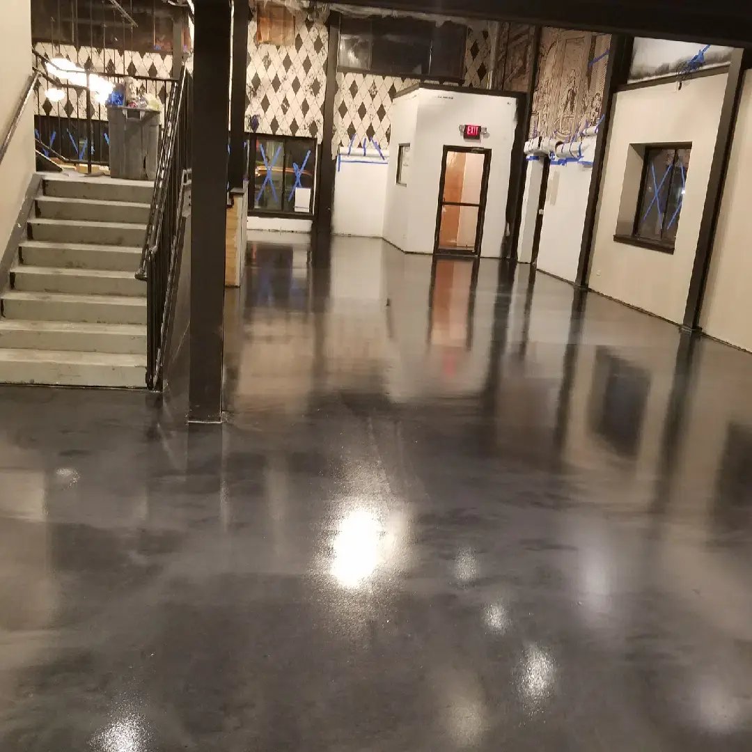 hallway with stairs with a grey Epoxy floor in a renovated building 