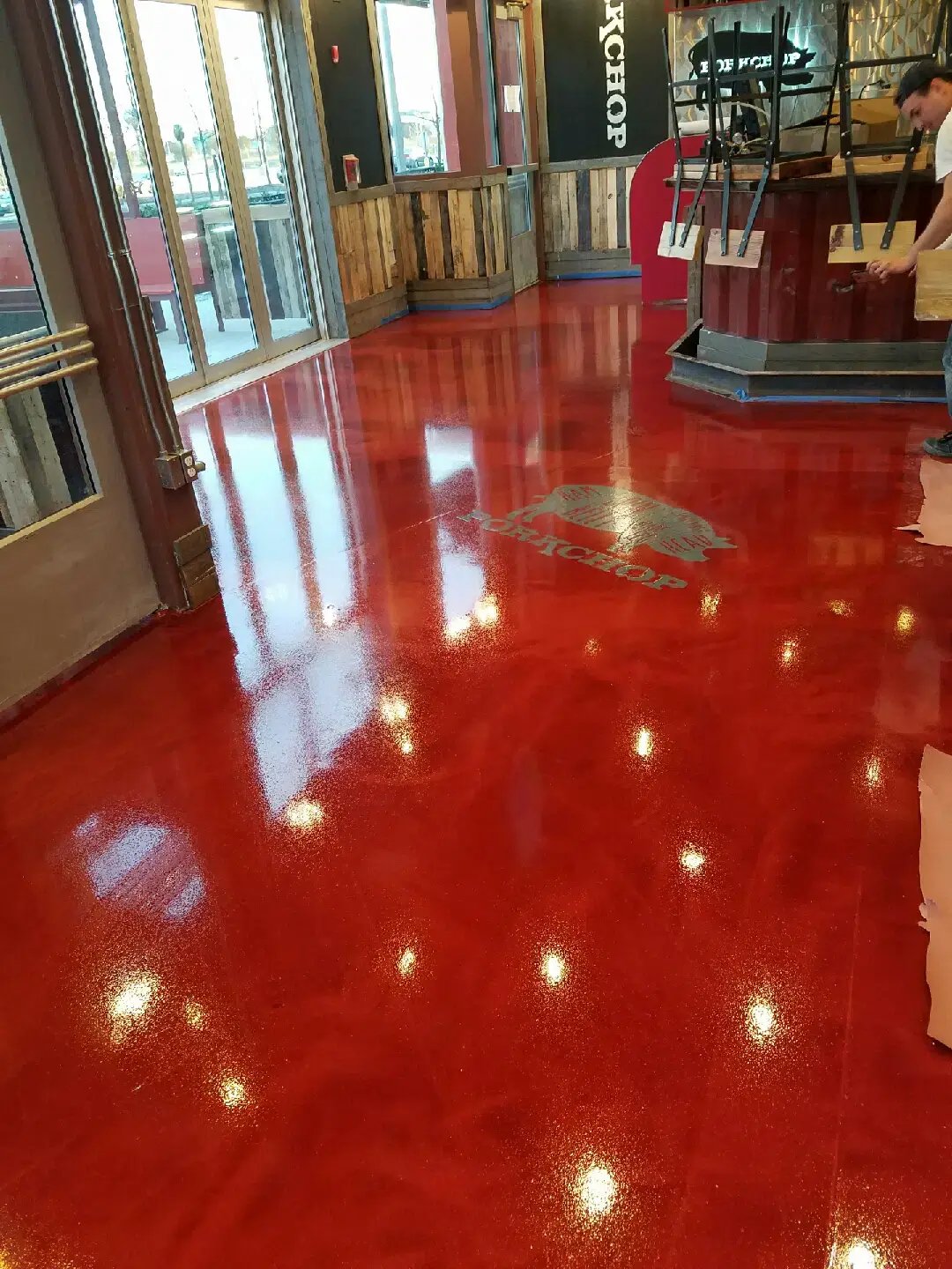 red epoxy floor with a custom logo installed by customcrete
