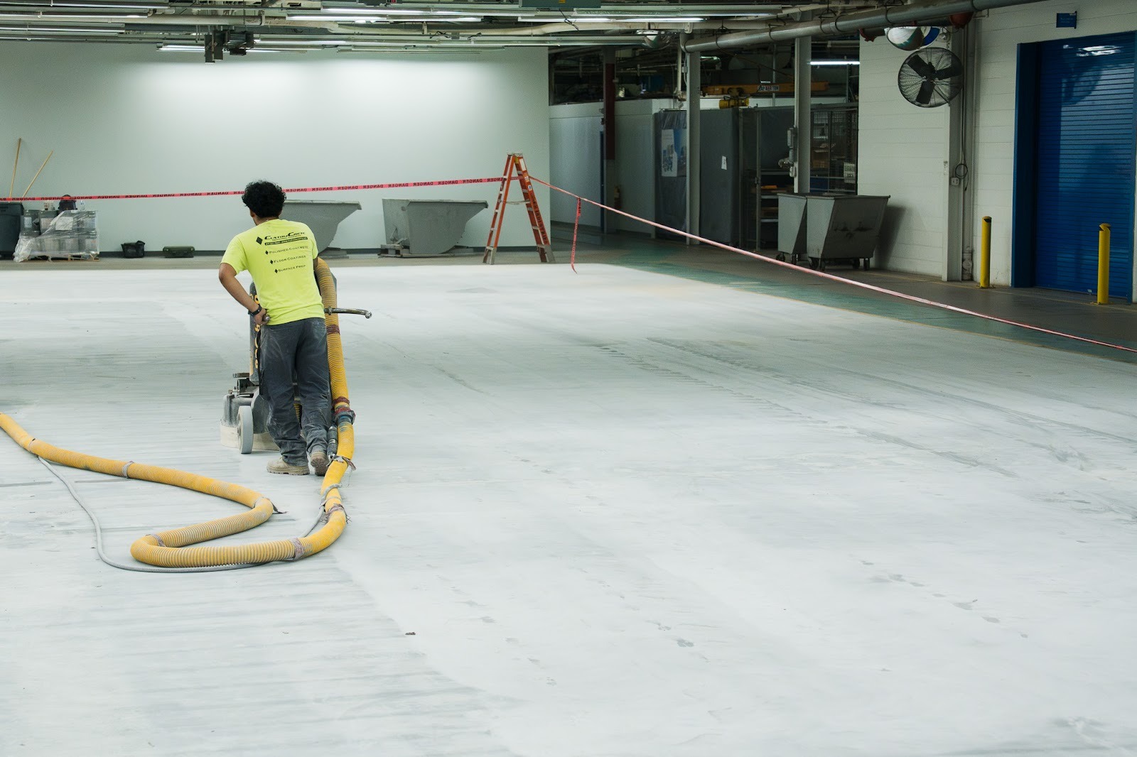 Grinding the surface of the concrete flooring